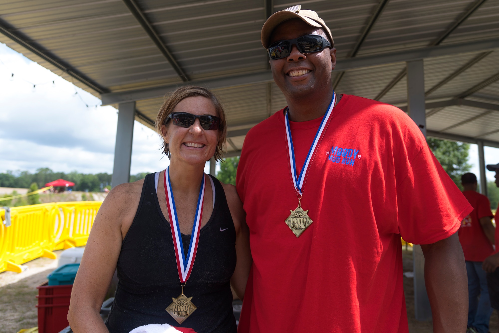 Col. Jennifer Short, left, 23d Wing commander, and Chief Master Sgt. James Allen, right, 23d Wing command chief, pose for a photo after the Moody Mud Run, May 4, 2019, at Possum Creek Off-Road Park in Ray City, Ga. The sixth annual Moody Mud Run had approximately 850 participants who had to overcome a series of obstacles on the 4 and 5-mile courses. The 32-obstacle course gave Airmen, families and the local community an opportunity to build camaraderie and teamwork skills. (U.S. Air Force Photo by Airman 1st Class Taryn Butler)