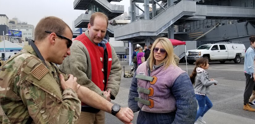 U.S. Air Force Staff Sgt. Jonathan McManus, 87th Security Forces Squadron military working dog handler, demonstrates how a bite suit works at the Intrepid Sea, Air & Space Museum during the Air Force Convention in New York City, May 4, 2019. Airmen assigned to Joint Base McGuire-Dix-Lakehurst and Joint Base Charleston took part at AFCON, an event held on the Intrepid Sea, Air & Space Museum that focuses on total force  Airmen telling the Air Force story through various global missions. (U.S. Air Force photo by Master Sgt. Dylan Bolander)