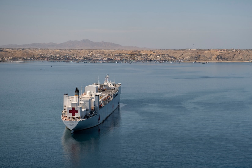 A hospital ship is anchored in the water.