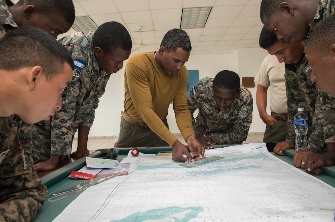 Navy engineman, attached to Coastal Riverine Squadron, discusses navigation with Honduran servicemembers during Southern Partnership Station 2014 (U.S. Navy/Rafael Martie)