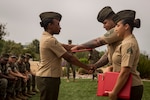 Marine Corps graduate (left) of Lance Corporal Leadership and Ethics Seminar 01-18 accepts certificate of completion from course director (middle) and her instructor (right), on Marine Corps Base Camp Pendleton, California, July 27, 2018 (U.S. Marine Corps/Brendan M. Mullin)