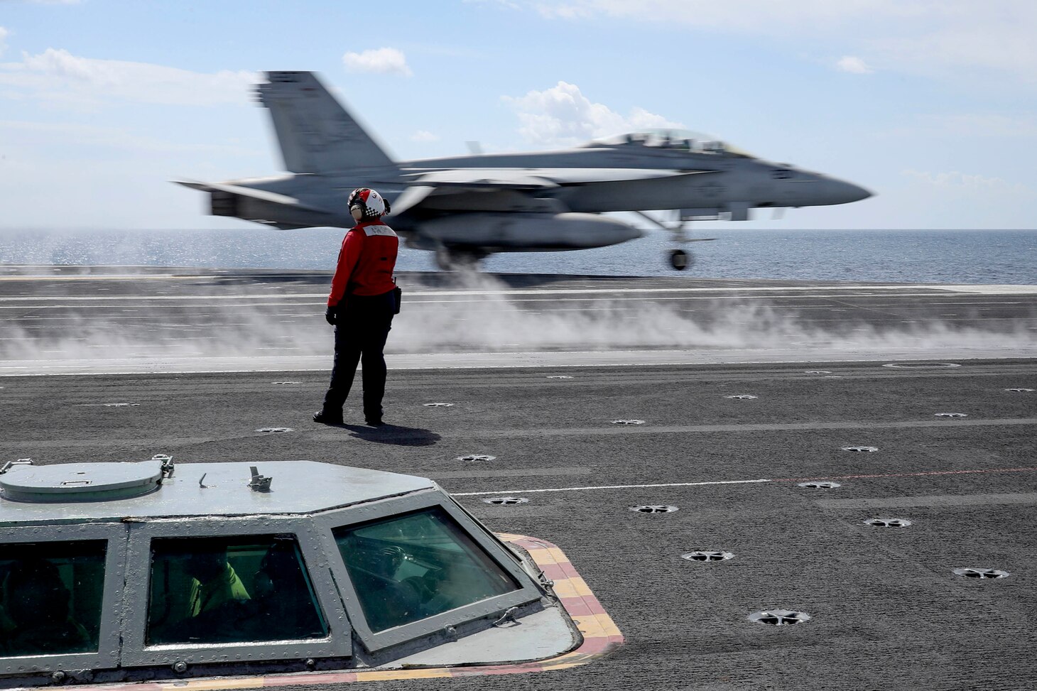 An F/A-18F Super Hornet from the "Jolly Rogers" of Strike Fighter Squadron (VFA) 103 launches from the flight deck of the Nimitz-class aircraft carrier USS Abraham Lincoln