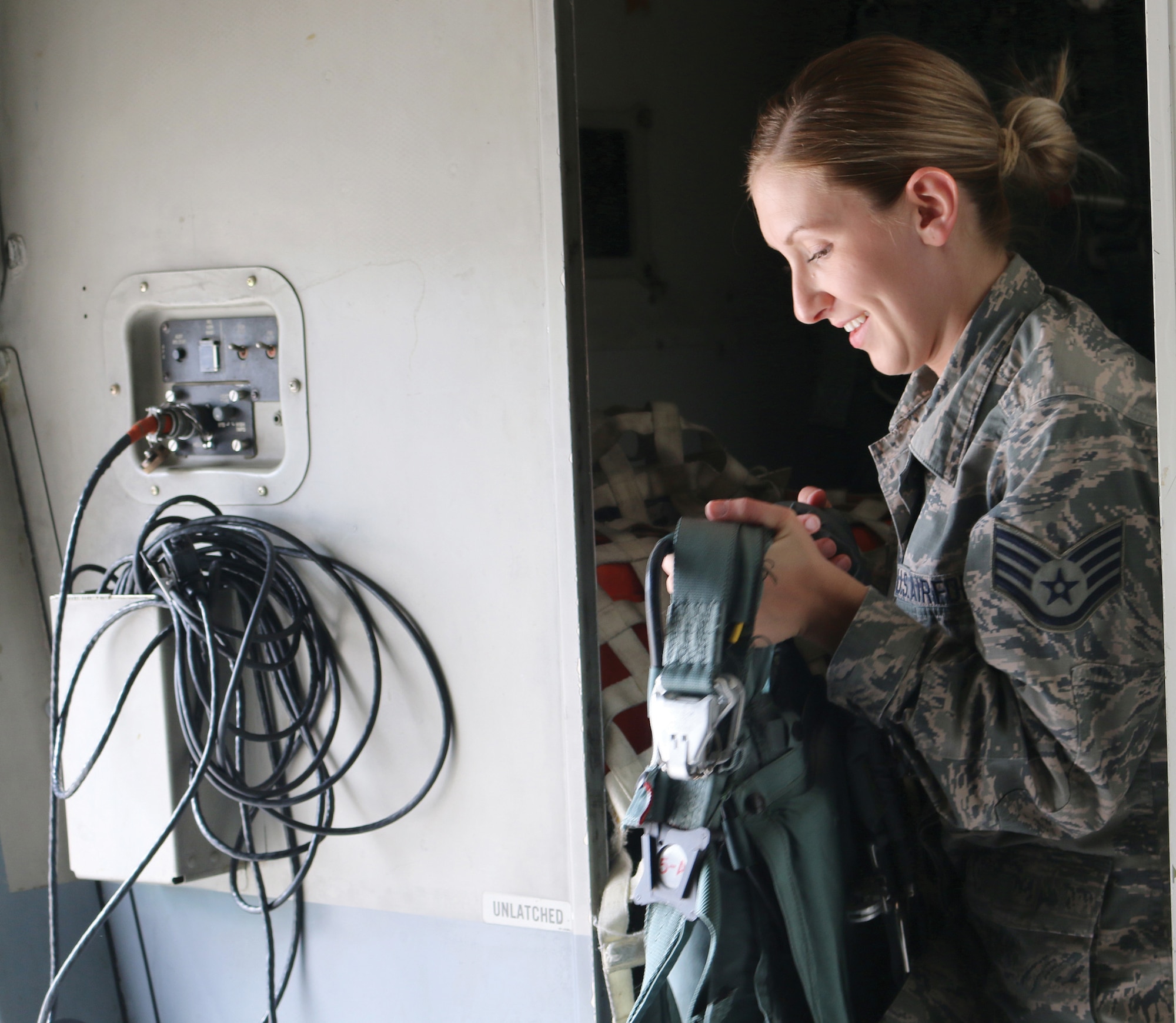 Staff Sgt. Addison Wyckoff, 445th Operations Support Squadron aircrew flight equipment technician, rotates a packed parachute off a C-17 Globemaster III, to be replaced by a newly-packed parachute, as part of a formal monthly inspection process.