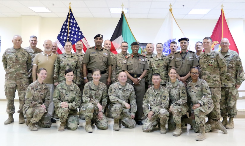 Soldiers of 452d Combat Support Hospital stand with distinguished visitors at Camp Arifjan, Kuwait, May 5, 2019.