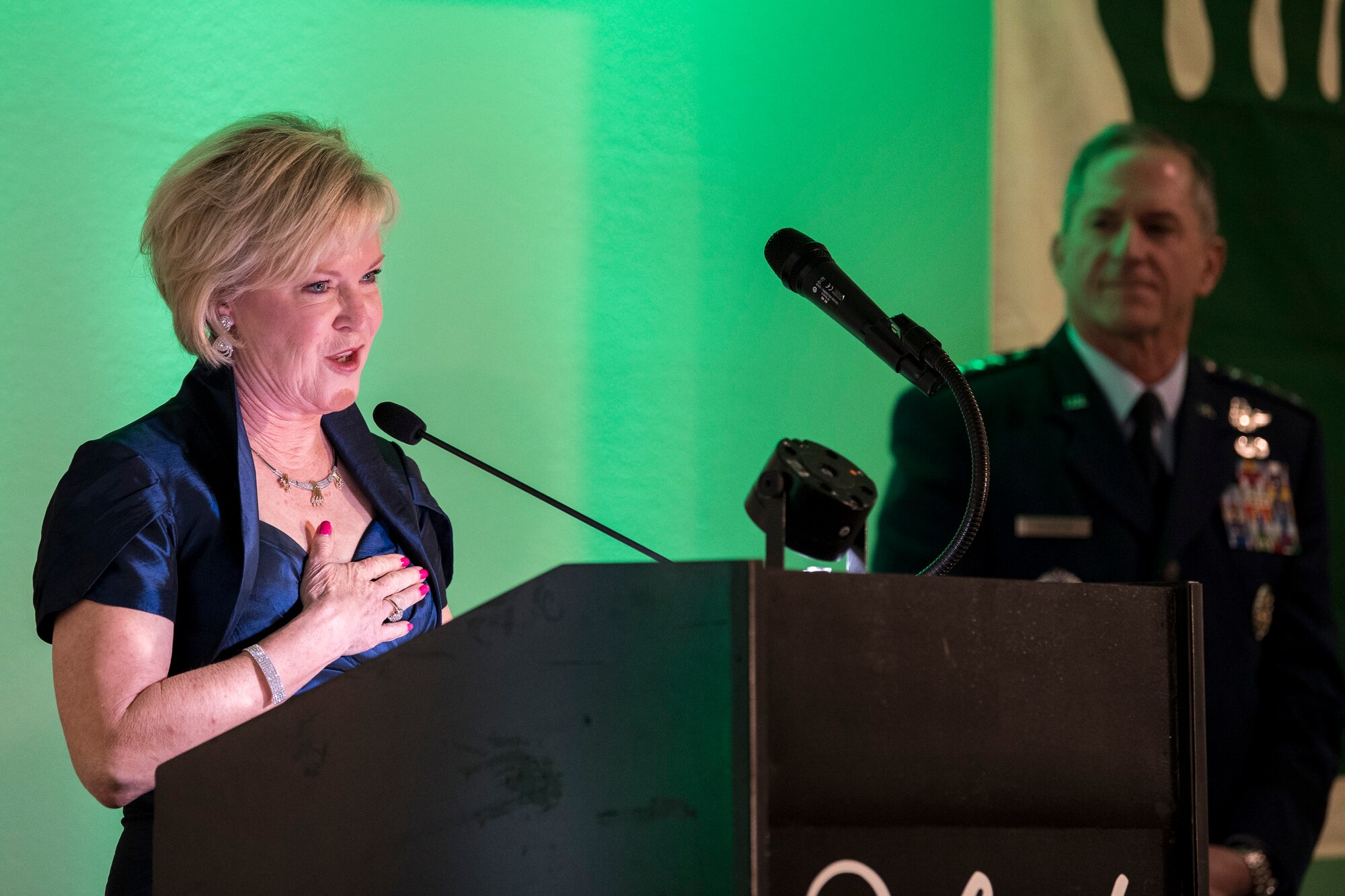 Dawn Goldfein thanks past and present members of the rescue community for their bravery as Air Force Chief of Staff Gen. David L. Goldfein listens, during the banquet celebrating the 50th reunion of the Jolly Green Association (JGA), May 4, 2019, in Fort Walton Beach, Fla. The JGA presented Airmen from the 41st Rescue Squadron (RQS) and the 48th RQS with the Rescue Mission of the Year award; the only non Air Force award recognized by the Air Force. Mrs. Goldfein spoke from her perspective as a spouse after Gen. Goldfein was shot down over Serbia on May 2, 1999. (U.S. Air Force Photo by Staff Sgt. Janiqua P. Robinson)