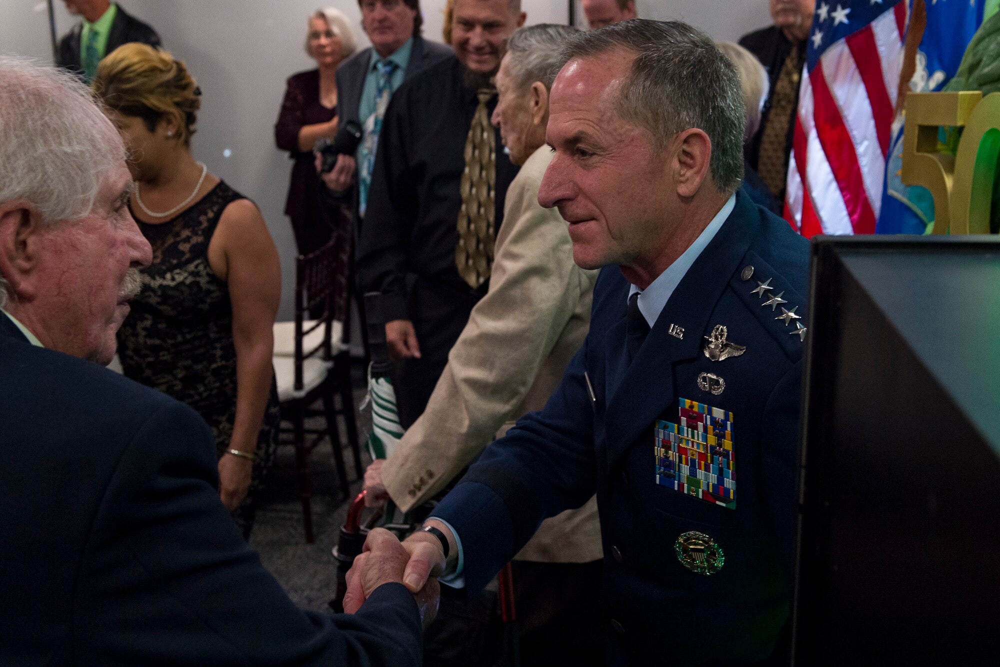 Air Force Chief of Staff Gen. David L. Goldfein, right, speaks with a member of the Jolly Green Association (JGA) during the banquet celebrating the 50th reunion of the JGA, May 4, 2019, in Fort Walton Beach, Fla. The JGA presented Airmen from the 41st Rescue Squadron (RQS) and the 48th RQS with the Rescue Mission of the Year award; the only non Air Force rescue award recognized by the Air Force. (U.S. Air Force Photo by Staff Sgt. Janiqua P. Robinson)