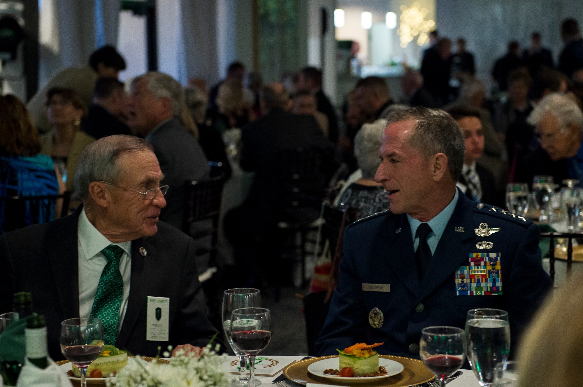 Air Force Chief of Staff Gen. David L. Goldfein, right, speaks with Barry Kamhoot, former Jolly Green Association (JGA) president, during the JGA 50th reunion banquet, May 4, 2019, in Fort Walton Beach, Fla. The JGA presented Airmen from the 41st Rescue Squadron (RQS) and the 48th RQS with the Rescue Mission of the Year award; the only non Air Force rescue award recognized by the Air Force. (U.S. Air Force Photo by Staff Sgt. Janiqua P. Robinson)