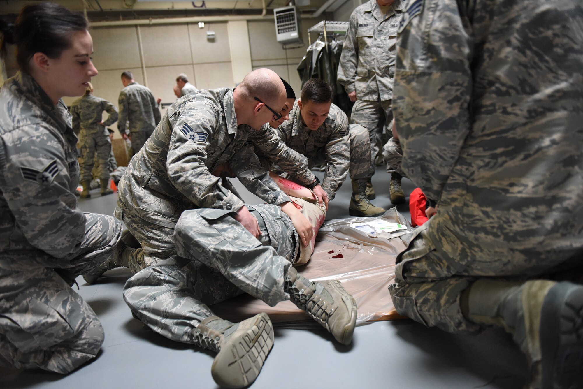 Airmen from the 419th Medical Squadron look for exit wounds on the victim of a simulated explosion during a recent mass casualty exercise at Hill Air Force Base, Utah