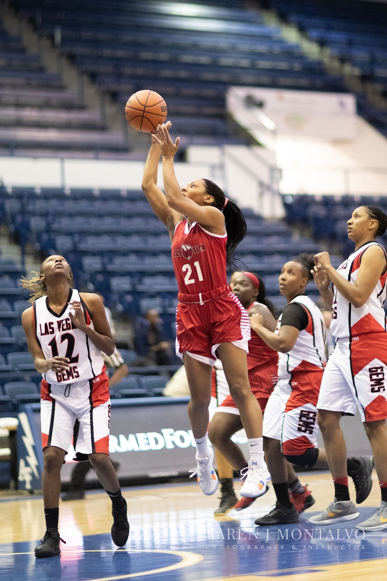 A player on the Joint Base Langley-Eustis Lady Raptors basketball team shoots a basketball at the Military Basketball Association Finals tournament game, at Colorado Springs, Colorado, April 14, 2019.