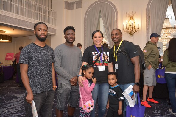 Tech. Sgt. Jairus McCain (right) stands with his wife, Kimberlin, their children and friends April 26, 2019, while registering at a Yellow Ribbon Reintegration Program training event in Chicago. McCain is a 302nd Logistics Readiness Squadron supply technician at Peterson Air Force Base, Colorado. (U.S. Air Force photo by Tech. Sgt. Samantha Mathison)