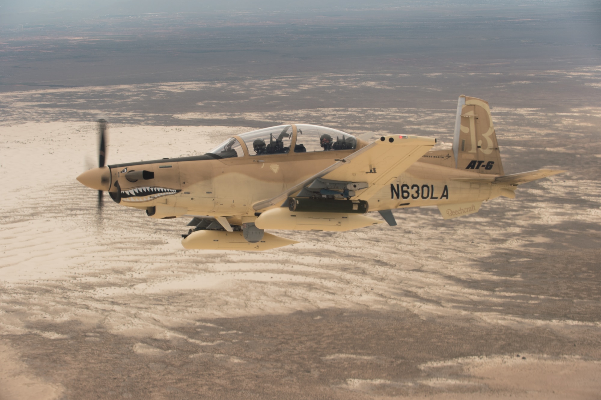 A Beechcraft AT-6B Wolverine experimental aircraft flies over White Sands Missile Range, N.M., July 31, 2017. Aircraft like the Wolverine and Embraer A-29 Super Tocano provide close-air support to U.S. allies and partners, and can also be outfitted with commercial off-the-shelf command and control units like the Airborne Extensible Relay Over-Horizon Network, or AERONet, increasing their combat effectiveness. (U.S. Air Force photo by Ethan D. Wagner)