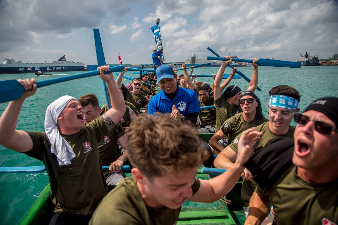 The Single Marine Program dragon boat team celebrates their victory during the 45th Annual Naha Dragon Boat Race May 5, 2019, at Naha Port, Okinawa, Japan. Local and military communities participated in the famous race, also known as the "Haarii." The SMP team placed first in their preliminary heat.