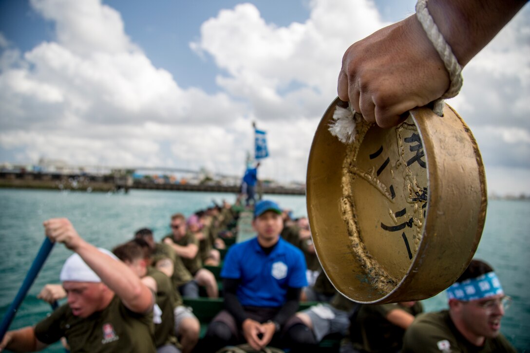 The Single Marine Program dragon boat team rows in sync to the beat of the gong during the 45th Annual Naha Dragon Boat Race May 5, 2019, at Naha Port, Okinawa, Japan. Local and military communities participated in the famous race, also known as the "Haarii." The SMP team placed first in their preliminary heat.