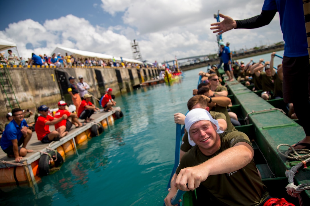 The Single Marine Program dragon boat team pushes off the dock to begin their race during the 45th Annual Naha Dragon Boat Race May 5, 2019, at Naha Port, Okinawa, Japan. Local and military communities participated in the famous race, also known as the "Haarii." The SMP team placed first in their preliminary heat.