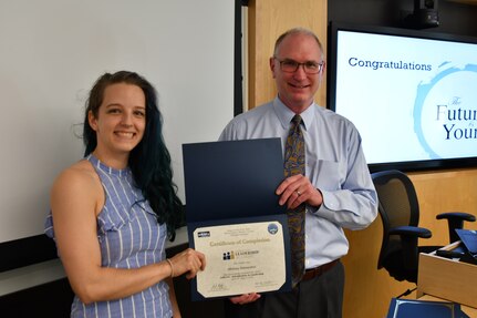 IMAGE: Gill Goddin, Naval Surface Warfare Center Dahlgren Division (NSWCDD) chief engineer, presents a certificate to a NSWCDD Leadership 101 graduate.