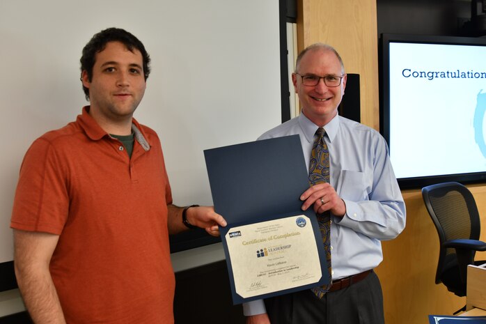 IMAGE: Gill Goddin, Naval Surface Warfare Center Dahlgren Division (NSWCDD) chief engineer, presents a certificate to a NSWCDD Leadership 101 graduate.