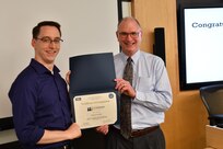 IMAGE: Gill Goddin, Naval Surface Warfare Center Dahlgren Division (NSWCDD) chief engineer, presents a certificate to a NSWCDD Leadership 101 graduate.