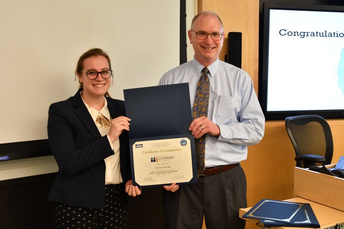 IMAGE: Gill Goddin, Naval Surface Warfare Center Dahlgren Division (NSWCDD) chief engineer, presents a certificate to a NSWCDD Leadership 101 graduate.