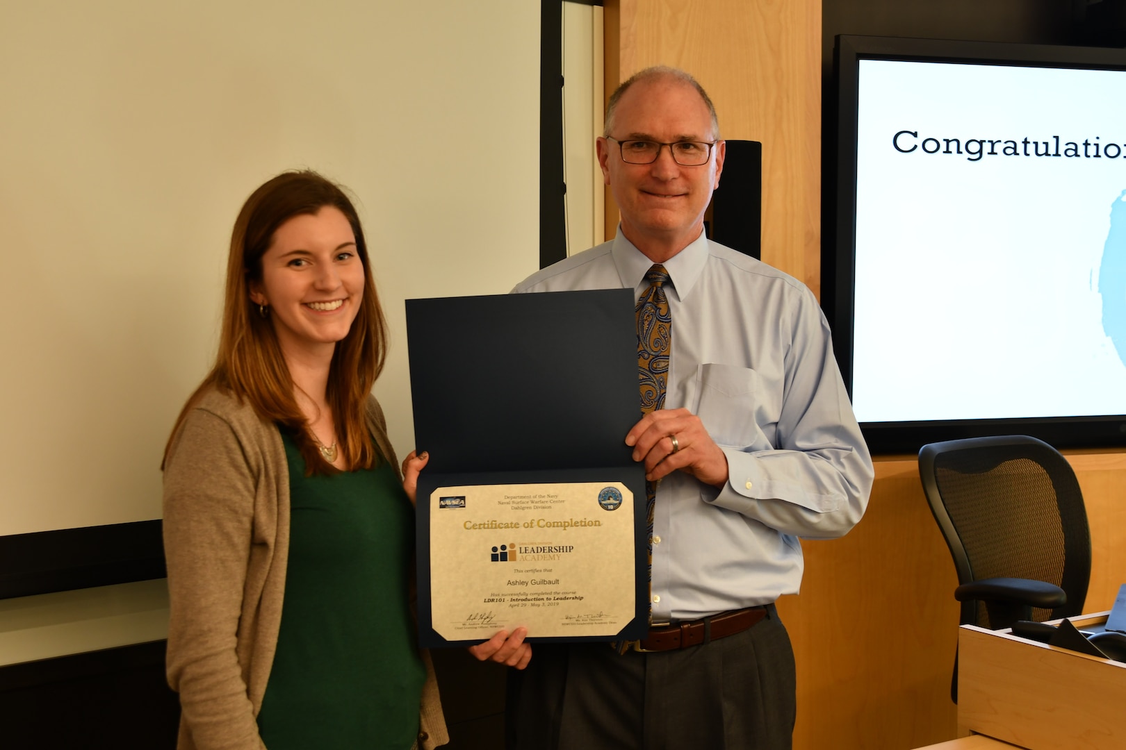 IMAGE: Gill Goddin, Naval Surface Warfare Center Dahlgren Division (NSWCDD) chief engineer, presents a certificate to a NSWCDD Leadership 101 graduate.