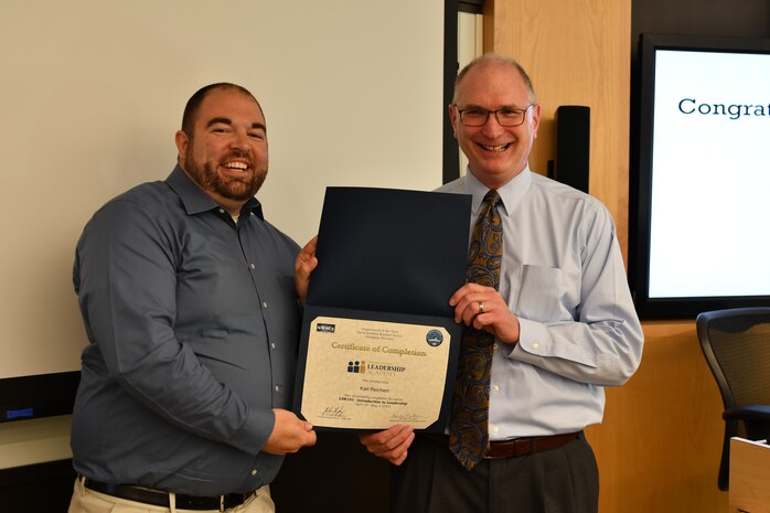 IMAGE: Gill Goddin, Naval Surface Warfare Center Dahlgren Division (NSWCDD) chief engineer, presents a certificate to a NSWCDD Leadership 101 graduate.