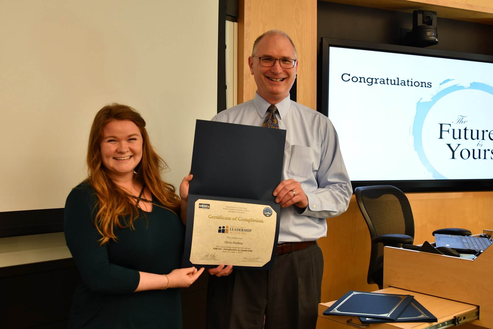 IMAGE: Gill Goddin, Naval Surface Warfare Center Dahlgren Division (NSWCDD) chief engineer, presents a certificate to a NSWCDD Leadership 101 graduate.