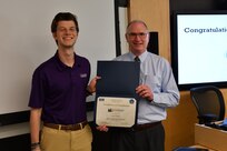 IMAGE: Gill Goddin, Naval Surface Warfare Center Dahlgren Division (NSWCDD) chief engineer, presents a certificate to a NSWCDD Leadership 101 graduate.