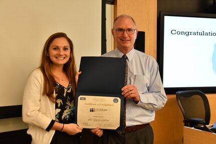 IMAGE: Gill Goddin, Naval Surface Warfare Center Dahlgren Division (NSWCDD) chief engineer, presents a certificate to a NSWCDD Leadership 101 graduate.