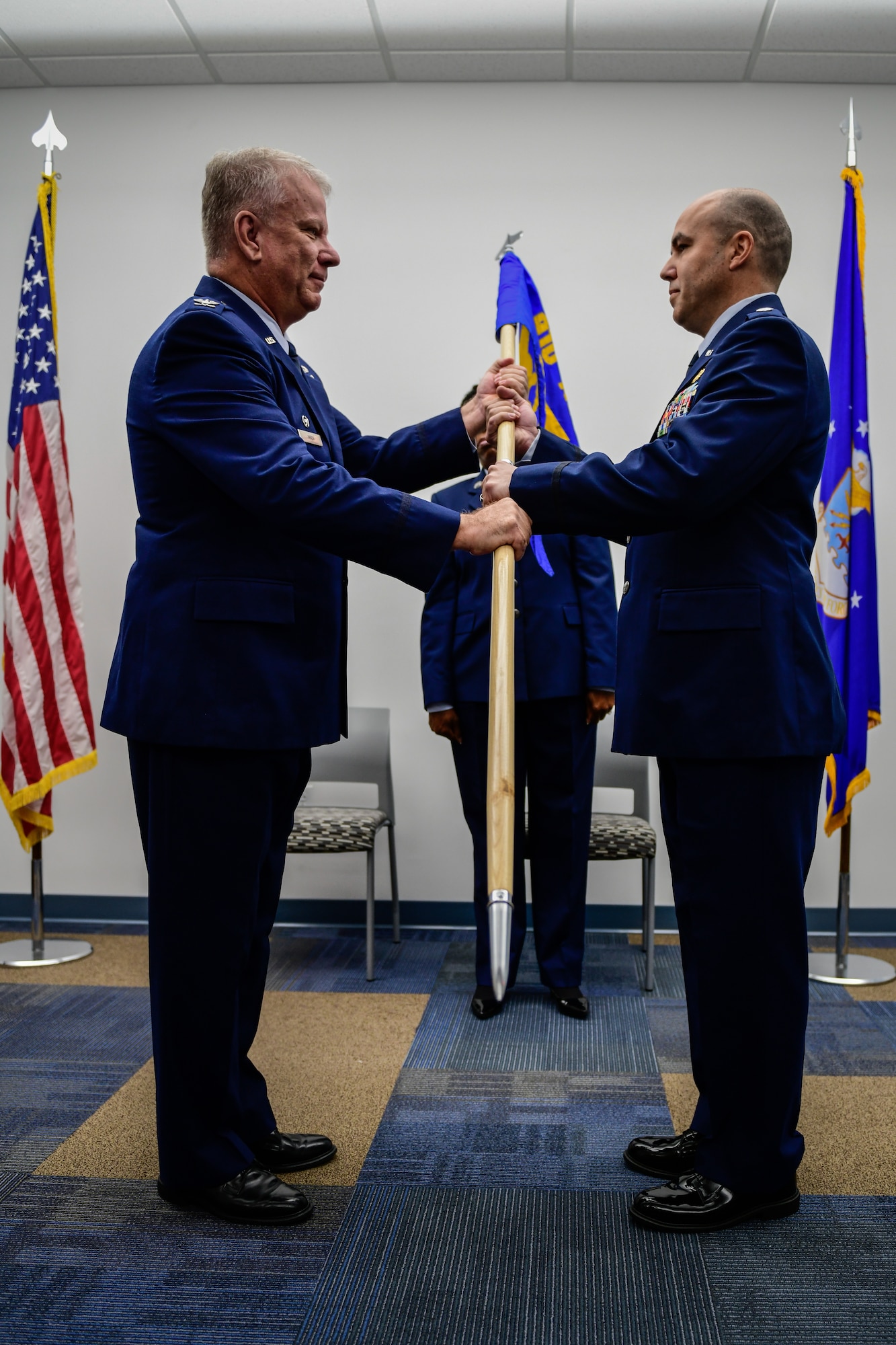 Lt. Col. Phillip Baker, the new 910th Civil Engineer Squadron commander, receives the 910th CES guidon from Col. Don Wren, commander of the 910th Mission Support Group, during a change of command ceremony, May 4, 2019, here.