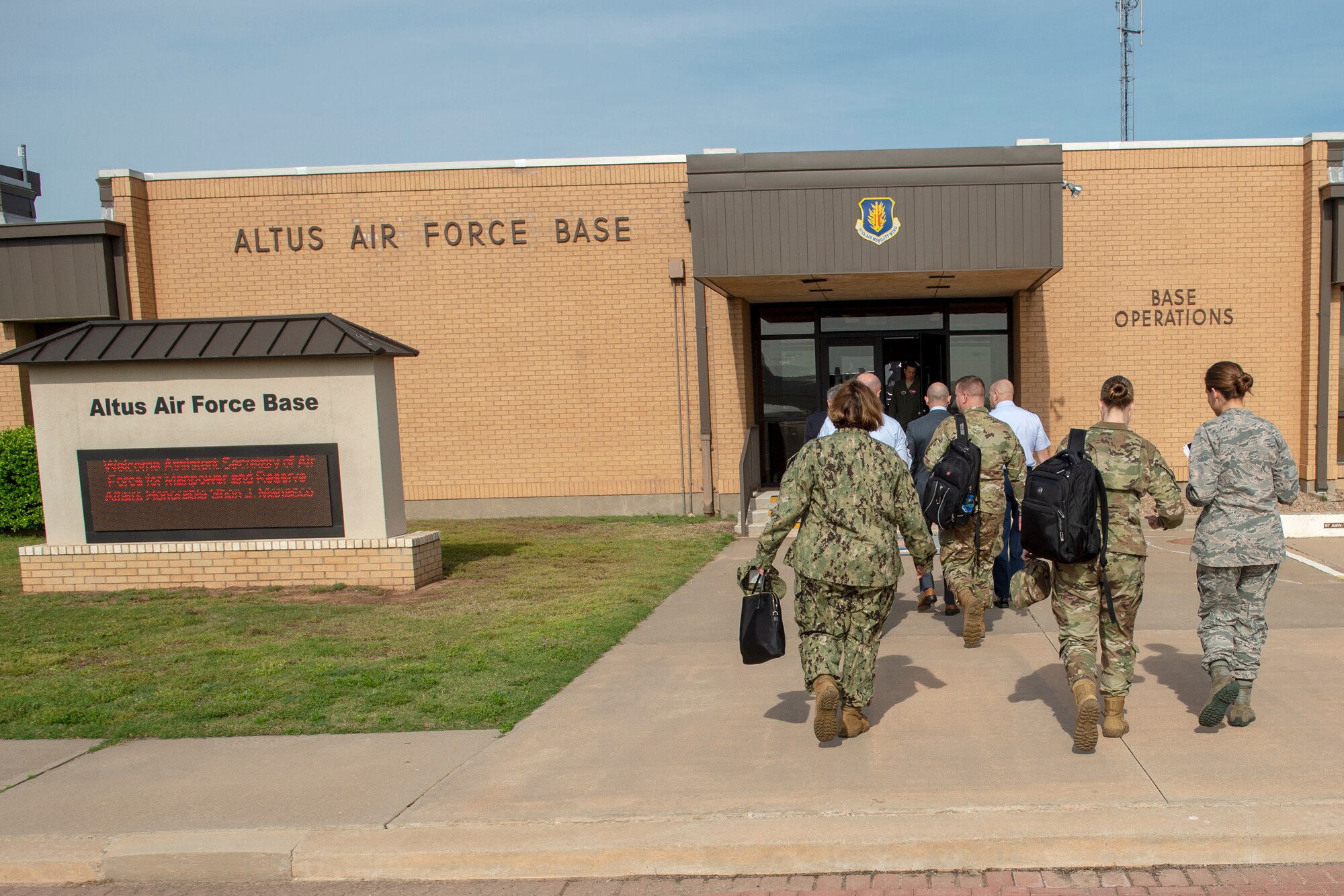 Distinguished Visitors from the Secretary of the Air Force and Navy Manpower/Reserve Affairs walk into Base Operations, May 6, 2019, at Altus Air Force Base, Okla. The visitors toured the wing and visited with leaders to discuss areas to improve upon. (U.S. Air Force Photo by Senior Airman Jackson N. Haddon)