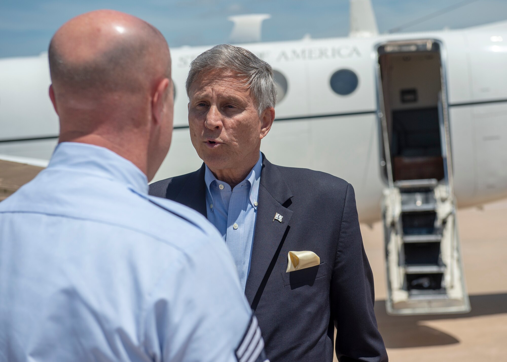 U.S. Air Force Chief Master Sgt. Randy Kay, 97th Air Mobility Wing command chief, speaks with the Honorable Gregory J. Slavonic, assistant secretary of the Navy for Manpower/Reserve Affairs, May 6, 2019, at Altus Air Force Base, Okla. The visitors toured the wing and visited with leaders to discuss areas to improve upon. (U.S. Air Force Photo by Senior Airman Jackson N. Haddon)