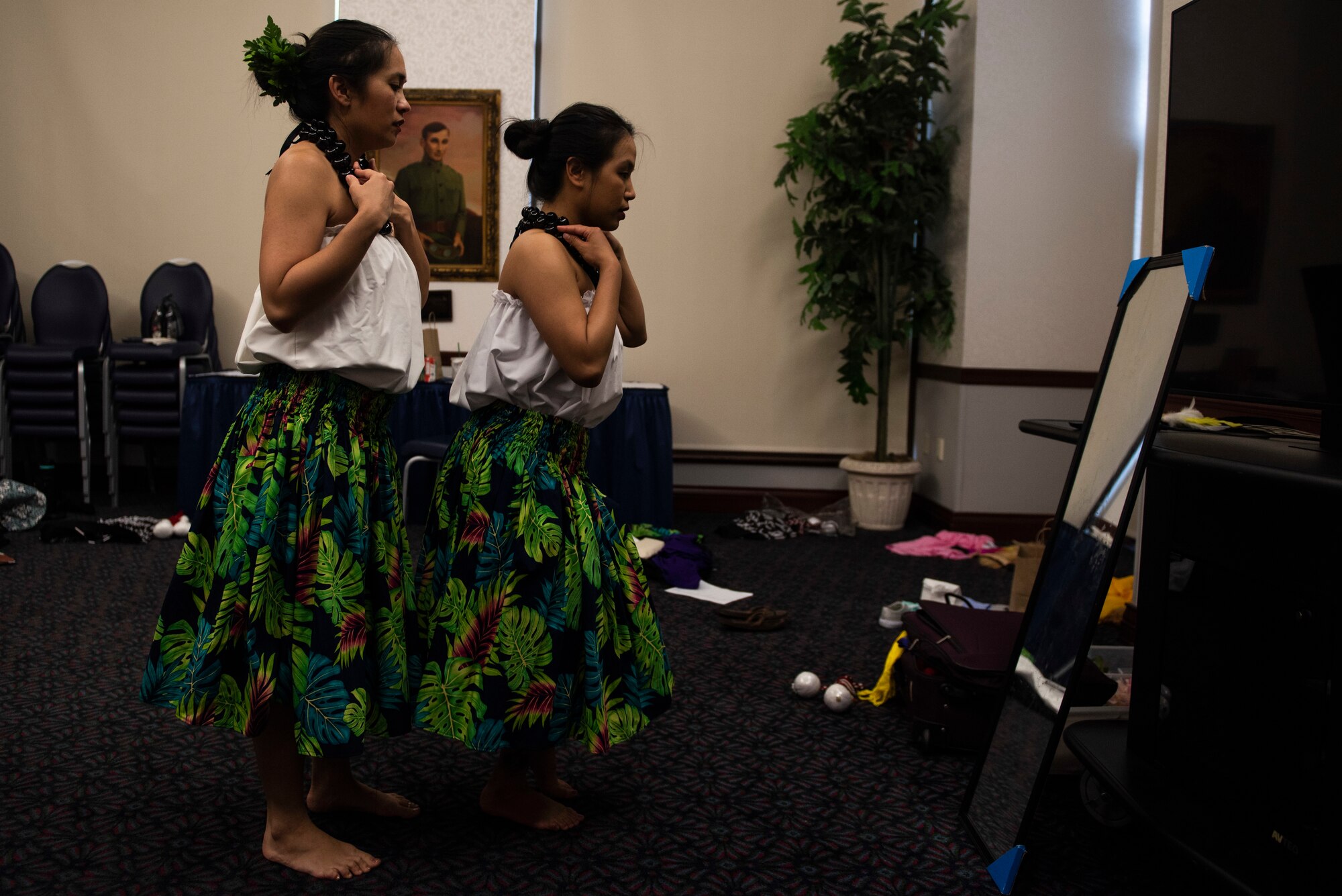 Keala Amorin and Senior Airman Tiffany Ellison, 436th Supply Chain Operations Squadron, prepare their outfits together prior to a hula performance on May 3, 2019 at Scott Air Force Base, Ill. Members of the 808 Ohana of the Midwest put on the performance as part of the Scott AFB Wingman Day Diversity Festival. (U.S. Air Force photo by Senior Airman Daniel Garcia)