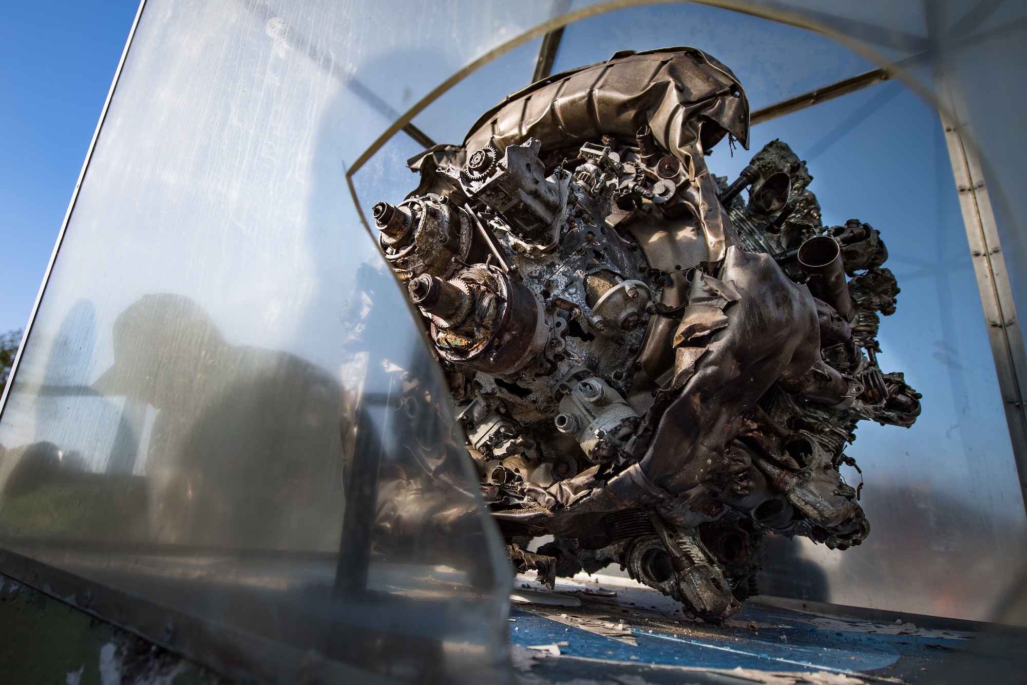 A U.S. Air Force Airman assigned to the 435th Construction Training Squadron, disassembles a display case, housing a WWII aircraft engine, at a memorial in Picauville, France, April 30, 2019. The 435th CTS Airmen spent several hours building a new case, removing the old one, and re-painting parts of the display. (U.S. Air Force photo by Staff Sgt. Devin Boyer)