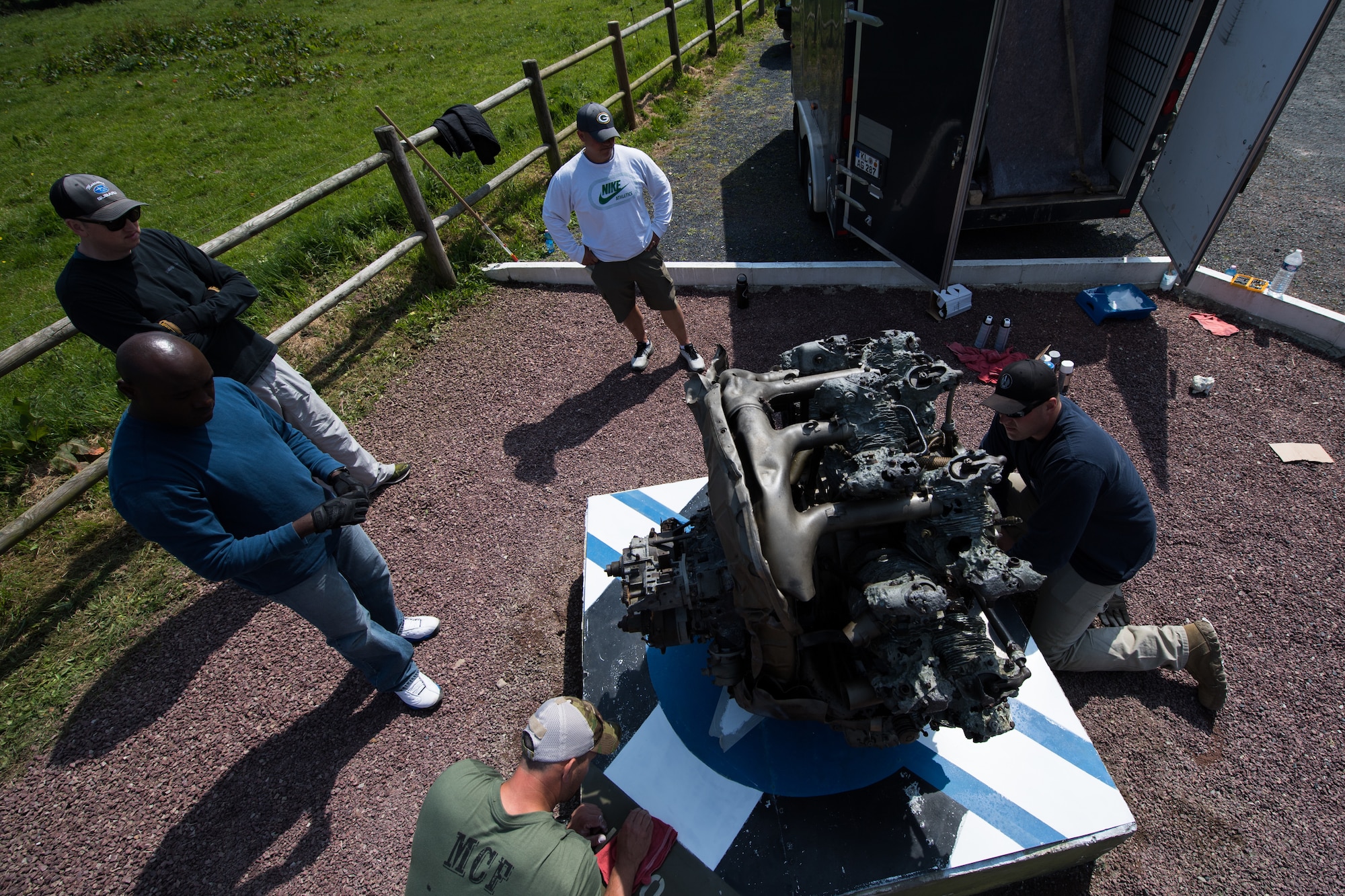 U.S. Air Force Airmen assigned to the 435th Construction Training Squadron refurbish a WWII aircraft engine display at a memorial in Picauville, France, April 30, 2019. Years of weathering rendered the display unpresentable. The 435th CTS team replaced the translucent case around the display with a new one, allowing people to see the aircraft engine inside. (U.S. Air Force photo by Staff Sgt. Devin Boyer)