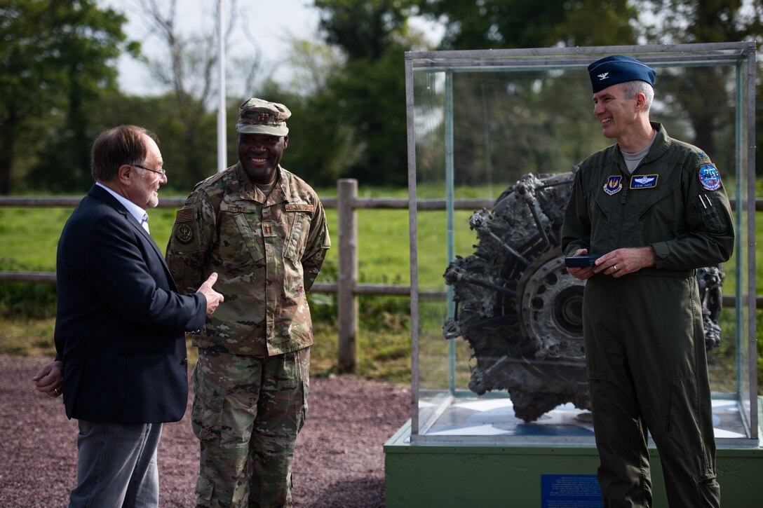 Philippe Catherine, Mayor of Picauville, France, speaks to U.S. Air Force Col. Steven J. Jantz, 435th Air Ground Operations Wing and 435th Air Expeditionary Wing vice commander, as Capt. Claude Betene A Dooko, 435th Contingency Response Support Squadron air advisor flight commander, center, interprets for Catherine during a ceremony at a WWII memorial in Picauville, May 1, 2019. The mayor thanked Jantz’ team for coming out to Picauville to refurbish the memorial. (U.S. Air Force photo by Staff Sgt. Devin Boyer)