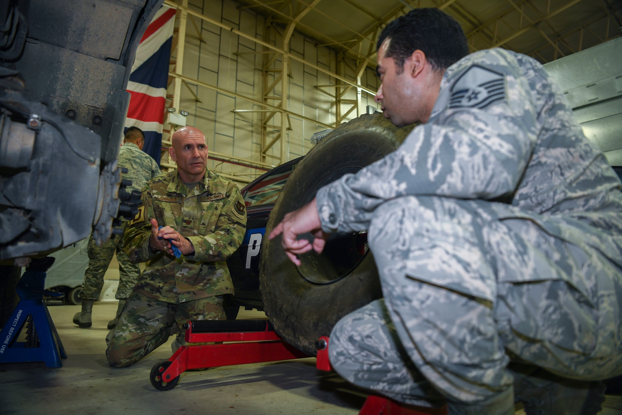 U.S. Air Force Maj. Anthony LaMagna, 100th Logistics Readiness Squadron commander and Master Sgt. Morales Davgene, 100th Logistics Readiness Squadron vehicle fleet manager, check the brakes of an LRS assigned vehicle at RAF Mildenhall, England, May 2, 2019. LaMagna has had his fair number of trials and tribulations. From coming in as an older Airman to losing family members; he overcame personal barriers and struggles throughout his career to fulfill his goal of commissioning. (U.S. Air Force photo by Senior Airman Alexandria Lee)