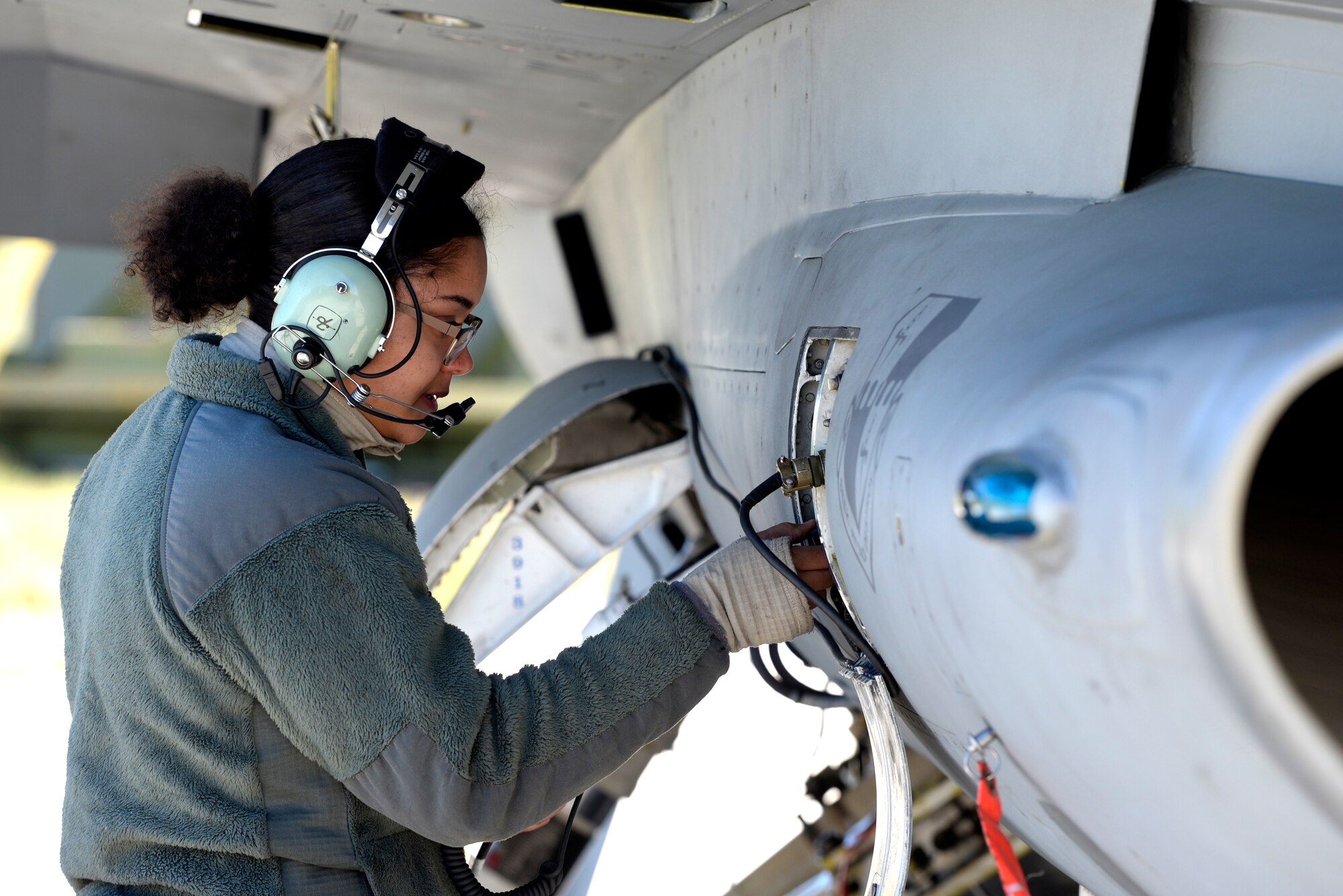 U.S. Air Force Staff Sgt. Reina Baker, 52nd Aircraft Maintenance Squadron F-16 Fighting Falcon dedicated crew chief, conducts F-16 Fighting Falcon ground communication equipment checks at RAF Lossiemouth, Scotland, May 7, 2019, during exercise Formidable Shield. The 52nd Fighter Wing, Spangdahlem Air Base, Germany, deployed F-16s and support personnel to support the U.S.-led exercise, conducted by Naval Striking and Support Forces NATO. The purpose of the training is to improve allied interoperability in a live-fire integrated air and missile defense exercise. (U.S. Air Force photo by Master Sgt. Austin M. May)