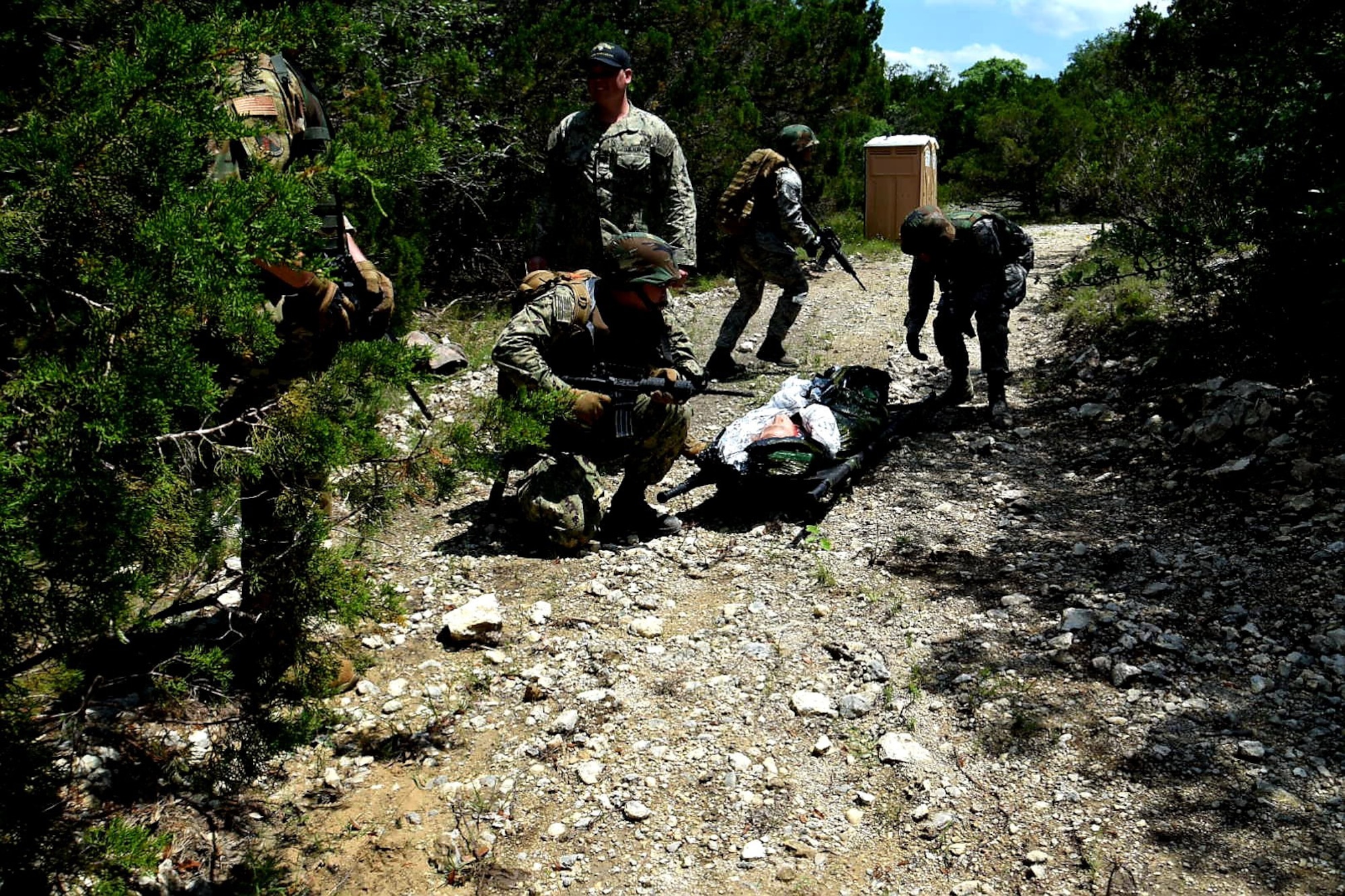 Reserve Citizen Airmen medics and a Navy Reserve corpsman move a simulated wounded patient during Operation Joint Medic May 5, 2019 at Joint Base San Antonio-Camp Bullis, Texas.