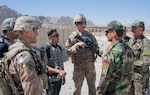 Sgt. 1st Class Jeremiah Velez, left, and Capt. David Zak, center, both advisors with the 1st Security Force Assistance Brigade's 3rd Squadron, speak with their Afghan National Army counterparts during a routine fly-to-advise mission at Forward Operating Base Altimur, Afghanistan, Sept. 19, 2018. (Photo Credit: Sean Kimmons)