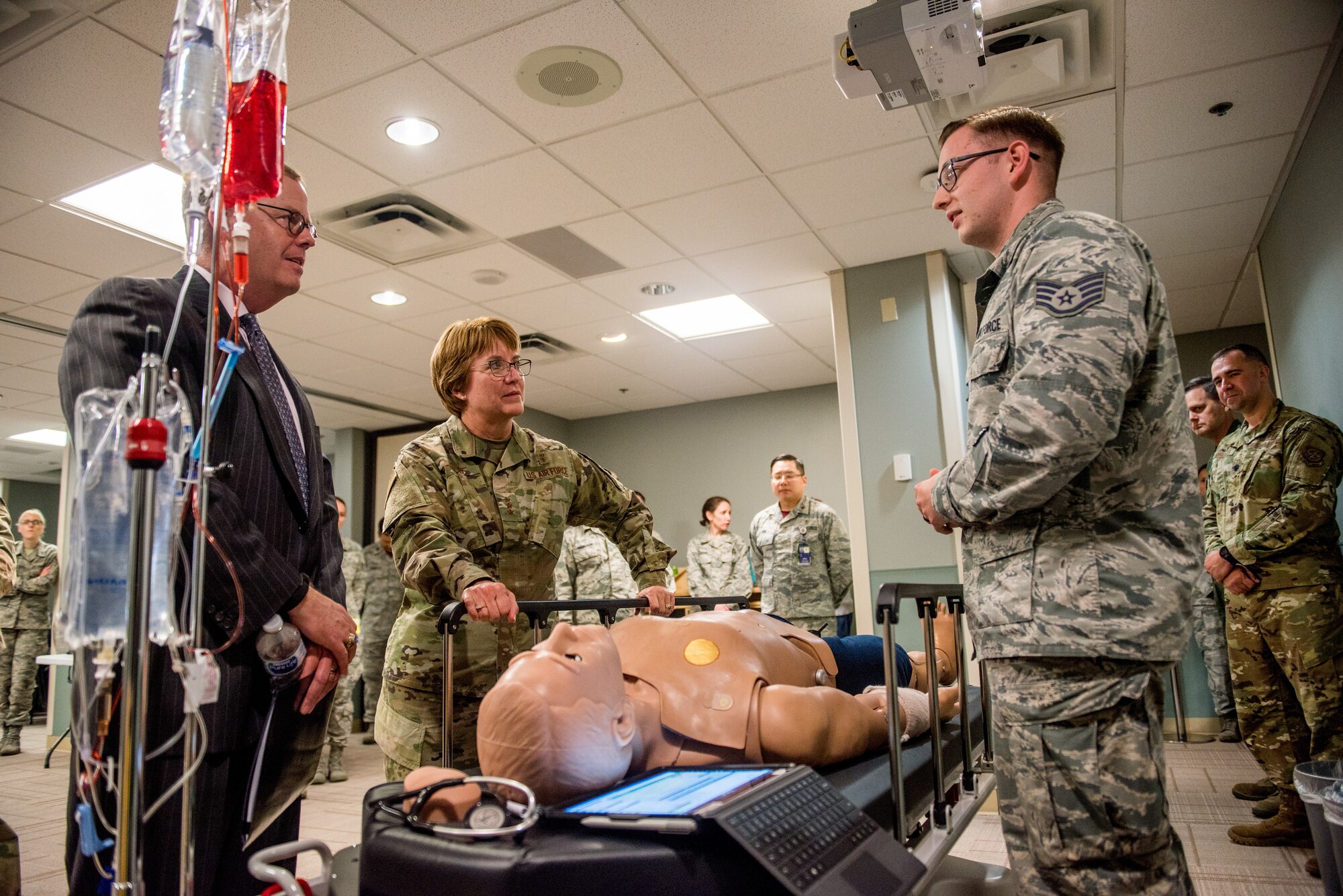 Staff Sgt. Logan Hallman, 436th Medical Group education and training, briefs Thomas McCaffery, the Principal Deputy Assistant Secretary of Defense for Health Affairs, and Lt. Gen. Dorothy Hogg, the Air Force Surgeon General, on patient trauma training at the Dover Air Force Base, Delaware, medical facility May 3, 2019. McCaffery and Hogg received briefings from Mental Health, Family Health, Public Health and other sections of the 436th MDG. (U.S. Air Force photo by Staff Sgt. Damien Taylor)