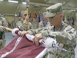 Command Sgt. Maj. Kristopher Orlowski, 452d Combat Support Hospital, prepares to case the unit's colors during the transfer of authority ceremony for United States Military Hospital - Kuwait at Camp Arifjan, Kuwait, May 6, 2019.