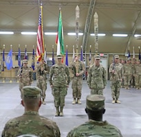 Col. Ellen Shannon-Ball, 452d Combat Support Hospital commander, and Command Sgt. Maj. Kristopher Orlowski, 452d CSH, stand at attention in front of the colors during the transfer of authority ceremony for United States Military Hospital - Kuwait at Camp Arifjan, Kuwait, May 6, 2019.