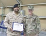 Kuwait Col. Raed Altajalli, assistant director of Kuwait North Military Medical Complex, and U.S. Army Col. Ellen Shannon-Ball, 452d Combat Support Hospital commander, stand together after he receives an award at Camp Arifjan, Kuwait, May 6, 2019.