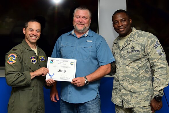Scott Baker, 47th Communications Squadron telecommunications manager, was chosen by wing leadership to be the “XLer” of the week, for the week of April 29, 2019, at Laughlin Air Force Base, Texas. The “XLer” award, presented by Col. Lee Gentile, 47th Flying Training Wing commander, is given to those who consistently make outstanding contributions to their unit and the Laughlin mission. (U.S. Air Force photo by Airman 1st Class Anne McCready)