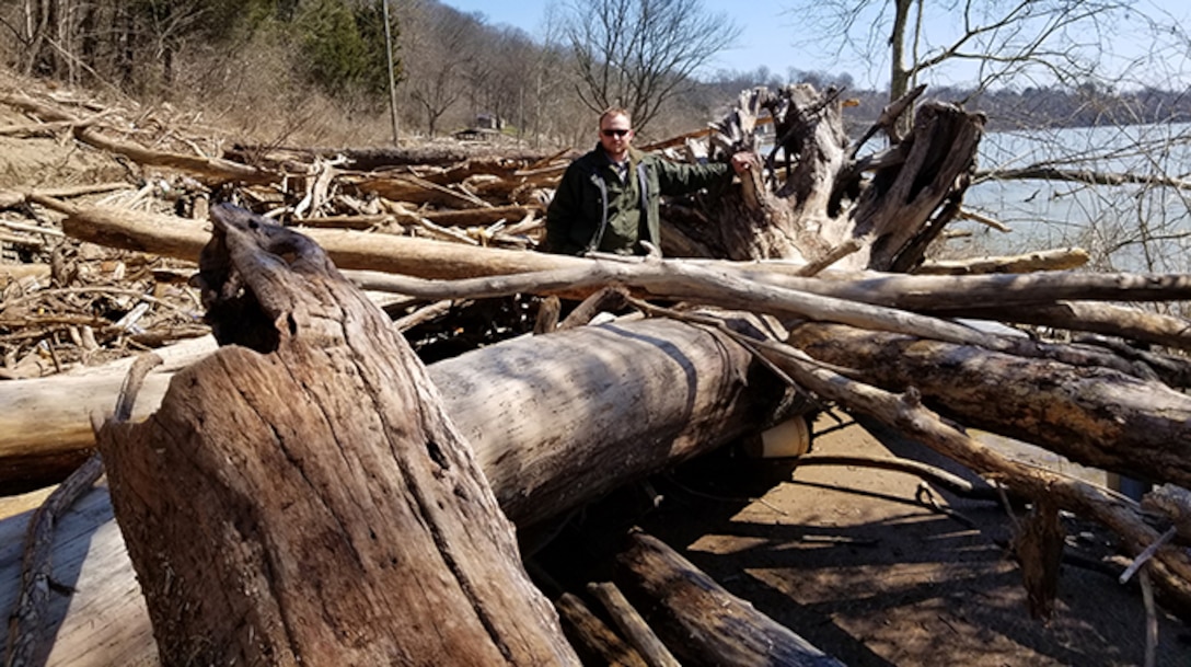 Park Ranger Tanner Rich stands in a debris field, which covers the road into Waitsboro Recreation Area March 19, 2019 on the shoreline of Lake Cumberland in Somerset, Ky. This photo was taken before cleanup operations began following high water at the U.S. Army Corps of Engineers Nashville District operated project. (USACE Photo)