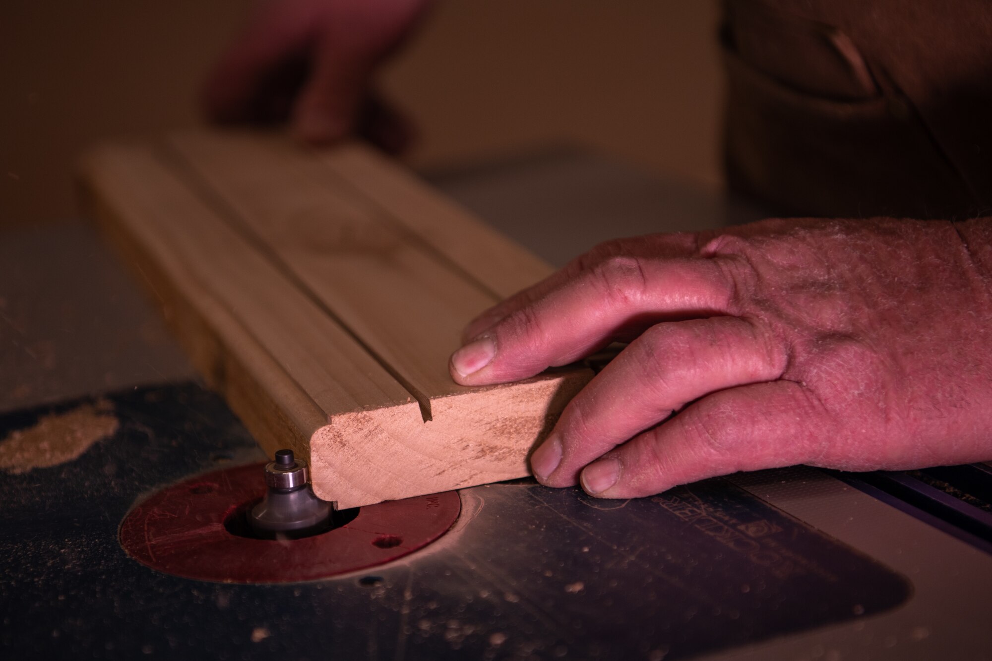 Kirk McCarty, 56th Force Support Squadron Wood Craft Shop manager, uses a router to put a decorative edge on a plank of wood May 4, 2019, at Luke Air Force Base, Ariz.