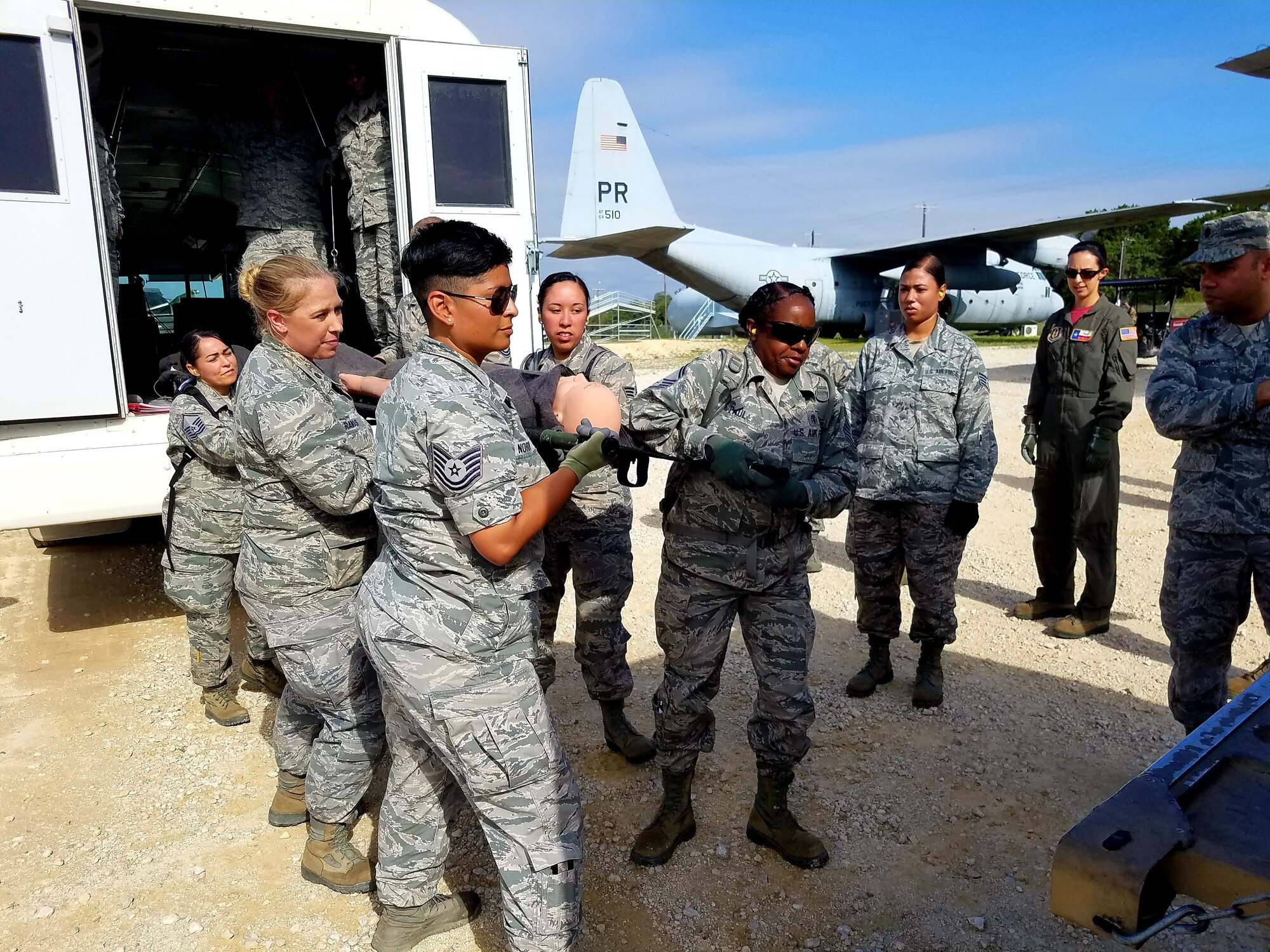 Reserve Citizen Airmen move a simulated wounded patient during Operation Joint Medic May 5, 2019 at Joint Base San Antonio-Camp Bullis, Texas. As part of their training,the medics moved simulated patients by stretcher onto and off of an ambulatory bus.