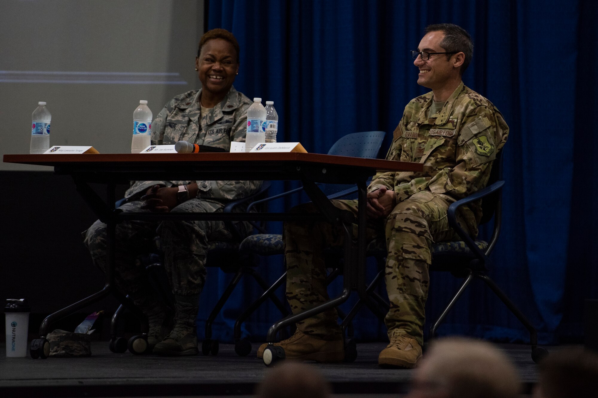 Col. Justin Demarco (right), 23 Wing vice commander, and fellow judge Maj. Lakeatta Tonge (left) from the 23d Medical Squadron, laugh during the second annual Moody Spark Tank competition, May 3, 2019, at Moody Air Force Base, Ga. The competition allows Airmen to showcase their ingenuity by presenting various time and money saving ideas that can benefit the Air Force. (U.S. Air Force photo by Airman 1st Class Joseph P. Leveille)