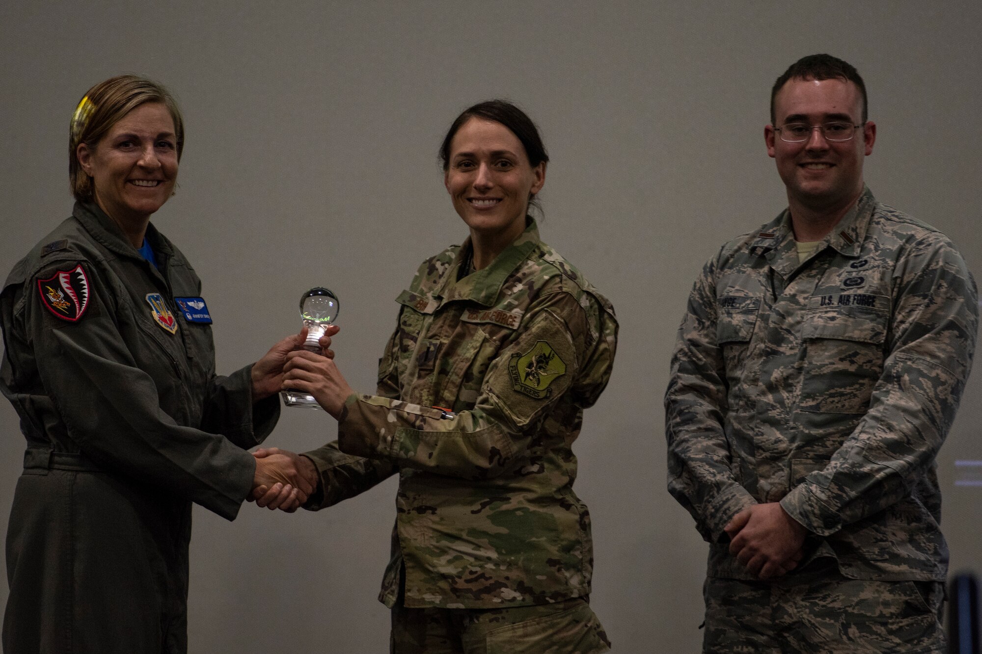 Col. Jennifer Short (left), 23d Wing commander, presents team 'NightWatch' the first place trophy for their idea May, 3, 2019, at Moody Air Force Base, Ga. Team 'NightWatch" pitched an idea that would help make a difference in tracking and assessing global threats. This idea received funding and support from Moody. (U.S. Air Force photo by Airman 1st Class Joseph P. Leveille)