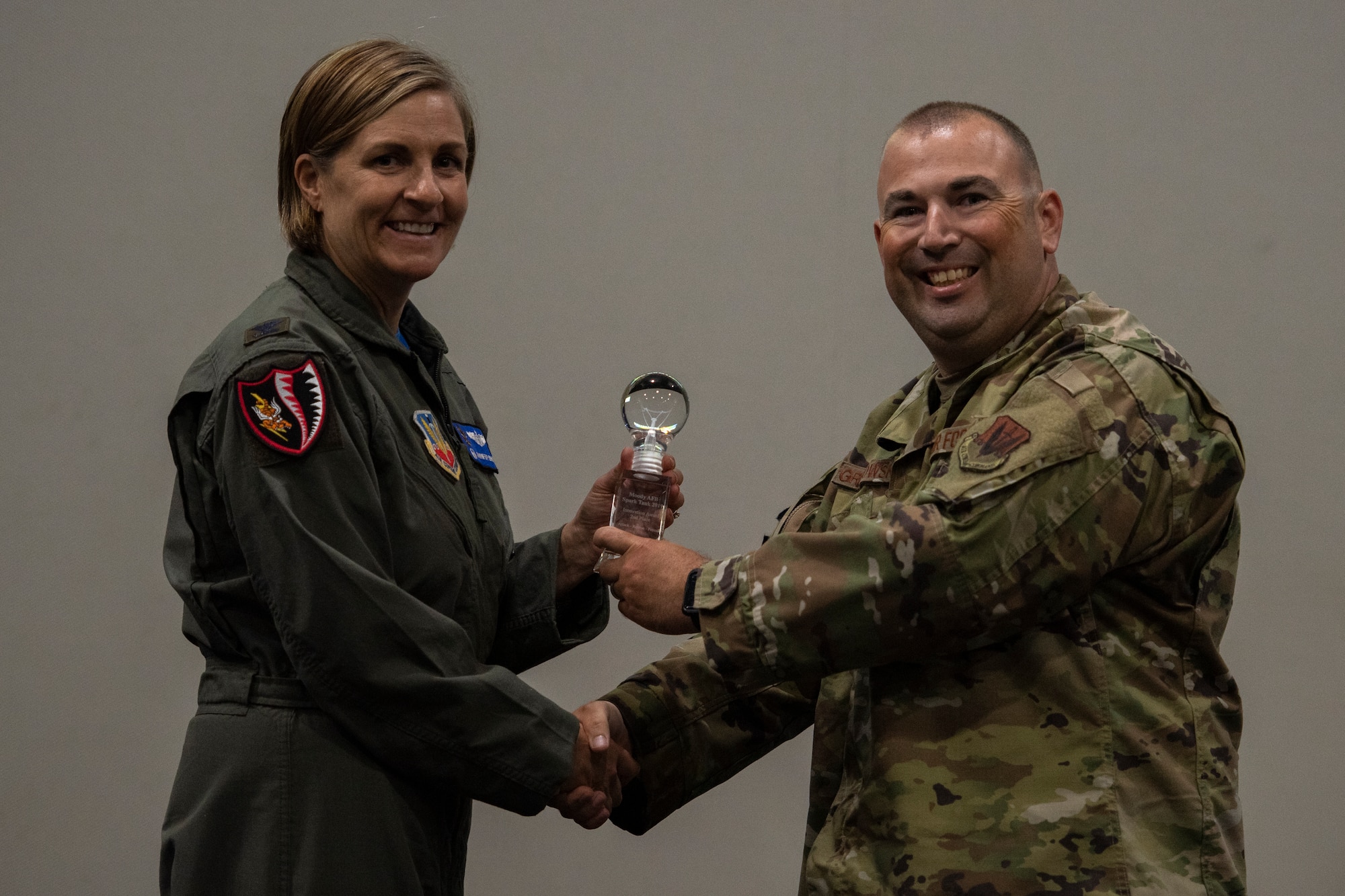 Col. Jennifer Short (left), 23d Wing commander, presents Tech. Sgt. Kevin Grabowsky from team 'Motorola Wave' with the second place trophy May, 3, 2019, at Moody Air Force Base, Ga.  The 'Motorola Wave' team pitched an idea that would increase land mobile radio capabilities on Moody. This idea received funding and support from Moody. (U.S. Air Force photo by Airman 1st Class Joseph P. Leveille