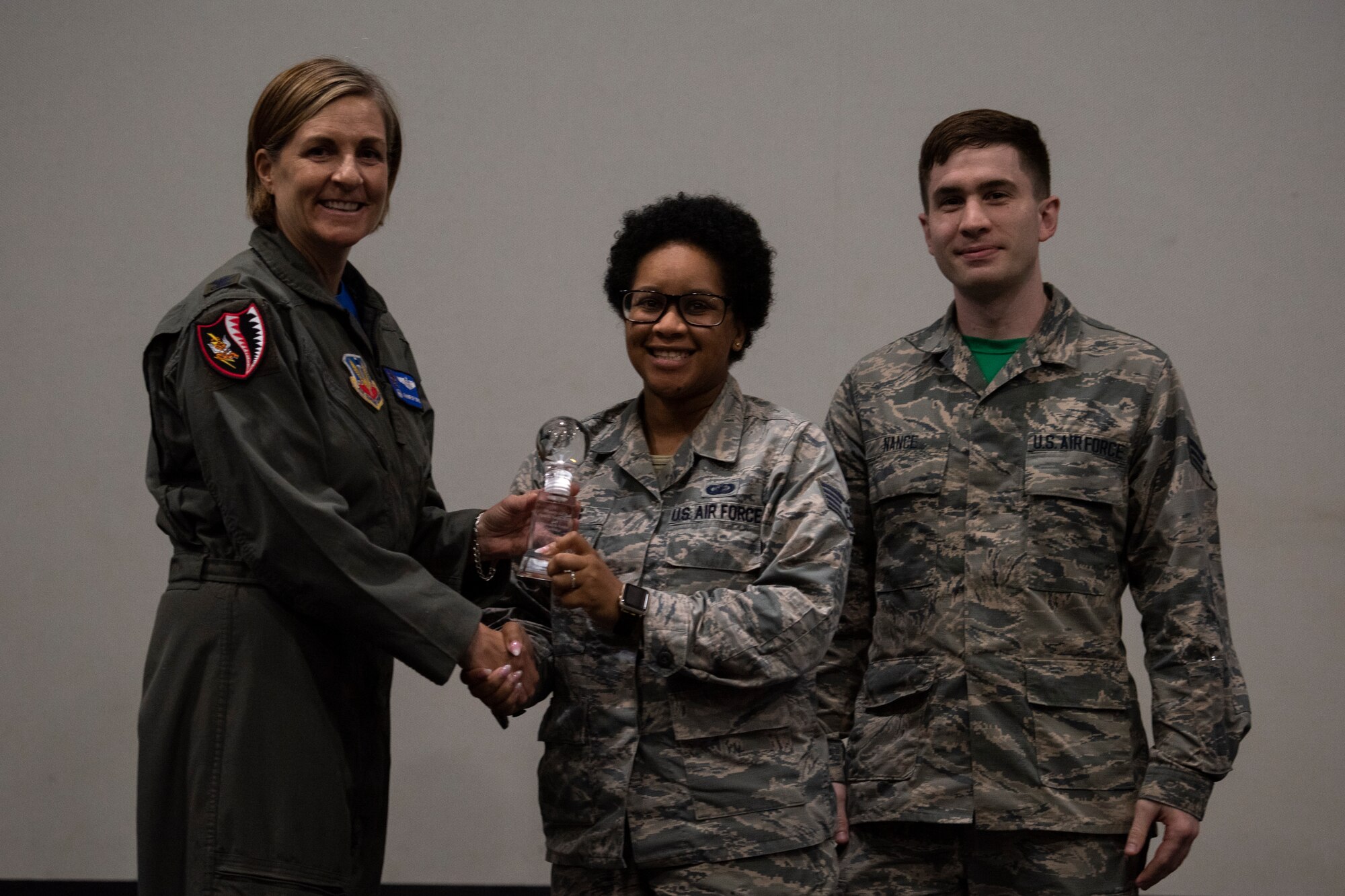 Col. Jennifer Short (left), 23d Wing commander, presents the 'Finance In-Processing' team the third place trophy for their idea. The 'Finance In-Processing' team pitched an idea that would help provide an interactive in-processing and travel voucher completion. This idea received funding and support from Moody. (U.S. Air Force photo by Airman 1st Class Joseph P. Leveille)